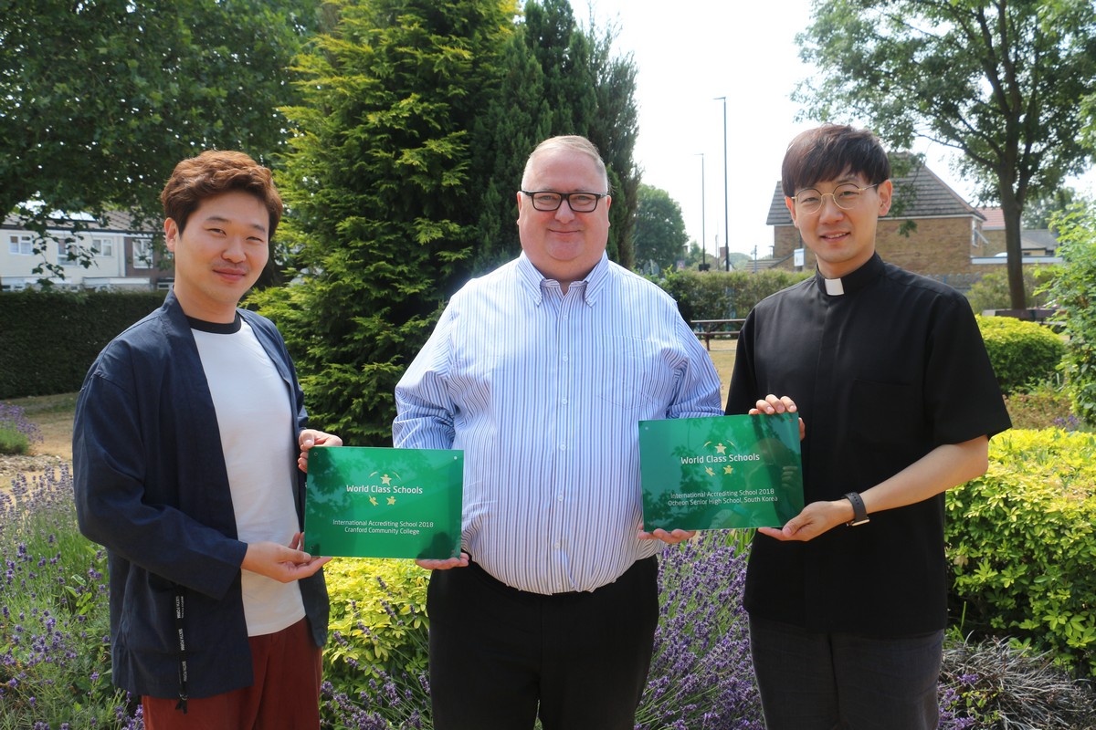Cranford Community College headteacher Kevin Prunty presents the WCSQM International Accreditation plaque to staff from Ocheon High School in South Korea